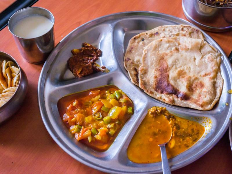 A standard vegetarian thali with dal, sabzi, chapatis and rice